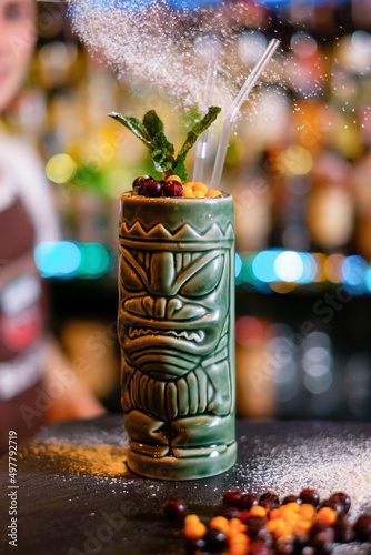 Tiki cocktail in a glass of natives with sugar powder.