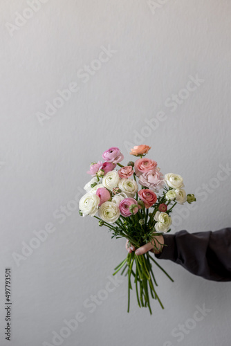 The girl is holding a bouquet of flowers. Ranunculus spring flower. Place for text © Антон Романюк