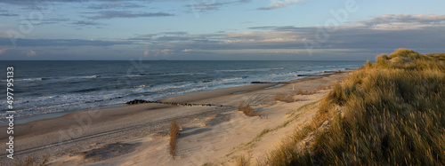 Panoramic view to the wide sandy beach with beautiful dune landscape. photo