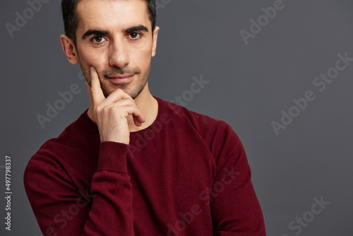 portrait man in a sweater posing emotions elegant style Gray background