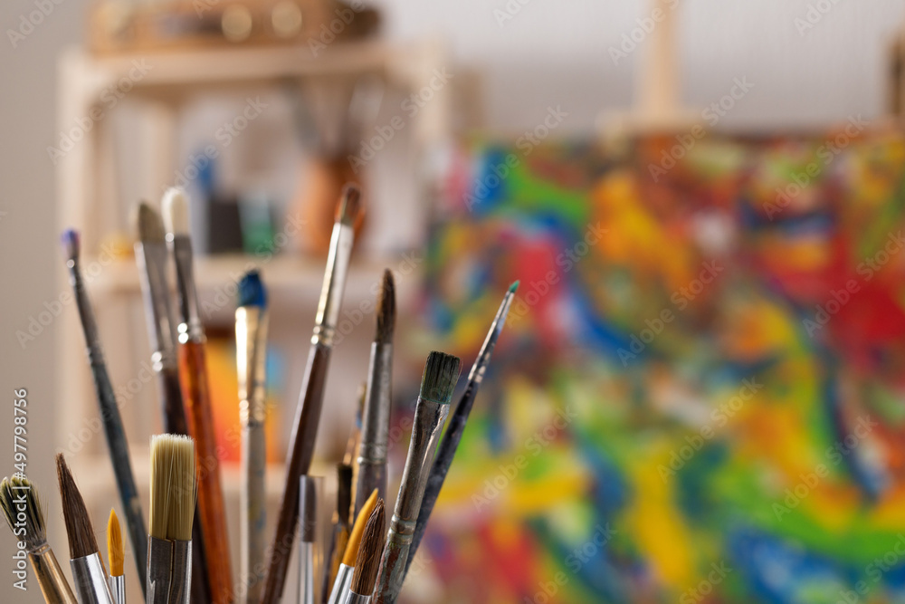 Fototapeta premium Paint brush and art painter tools at wood background. Paintbrush for painting in artist studio