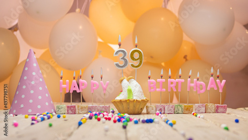 Beautiful background happy birthday number 39 with burning candles, birthday candles pink letters for thirty nine years. Festive background with balloons photo