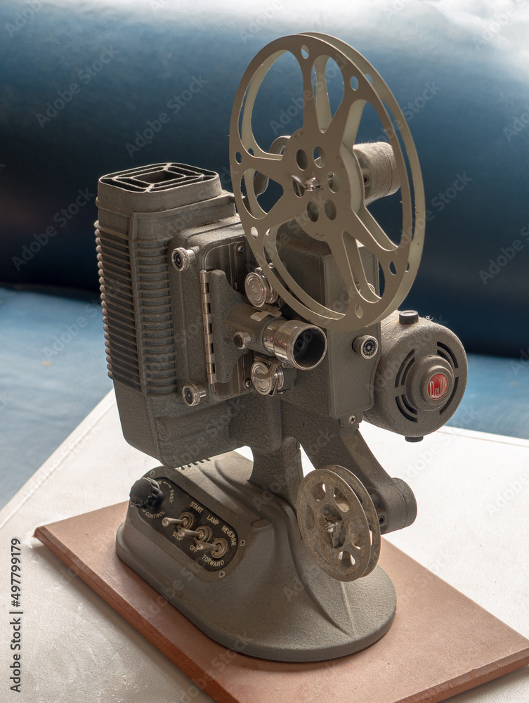 Dejur gray 8mm film projector with a blue background