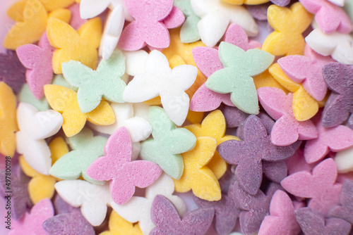 Colorful butterflies, popular sugar confectionery sprinkles, solid background.