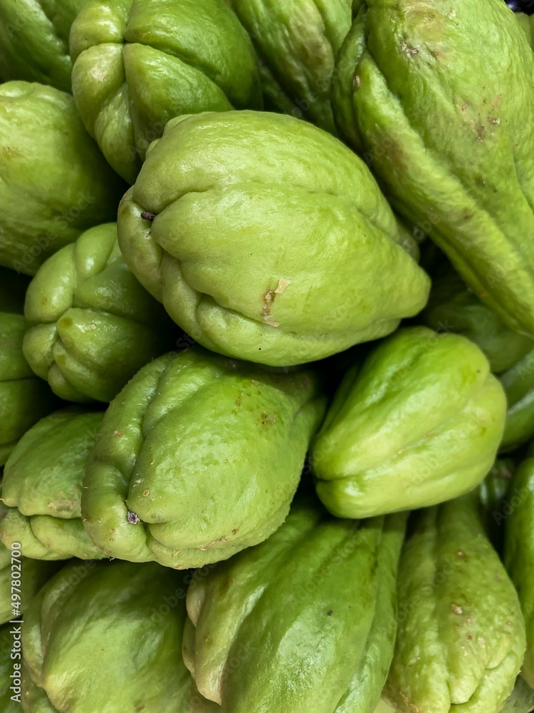 Brazilian green chayote. Closeup of various vegetables stacked. Brazilian green chayote. Closeup of various vegetables stacked.