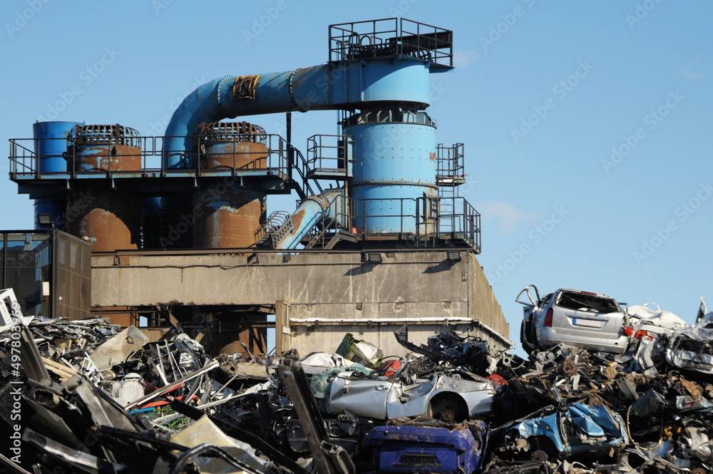 Metal recycling factory with pile of scrap with blue sky