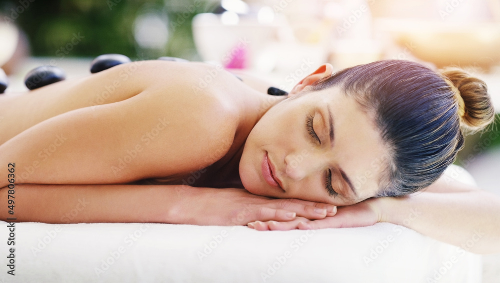 Cant help but drift away in such a magical state. Shot of a young woman getting a hot stone massage at a spa. Cant help but drift away in such a magical state. Shot of a young woman getting a hot stone massage at a spa.