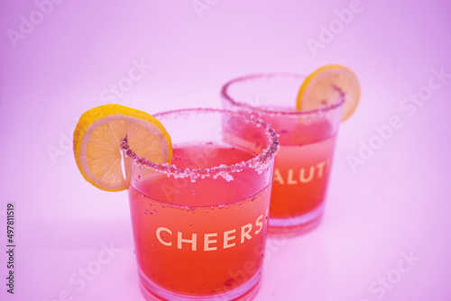 Summer Raspberry Lemon Cocktail Mix with lemon slices on glasses with Cheers and Salut