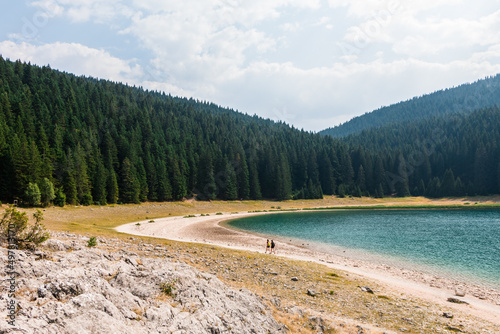 Walk along the mountain lake. Black lake in Durmitor national Park. Montenegro photo