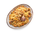 Plate of traditional pilaf on white background