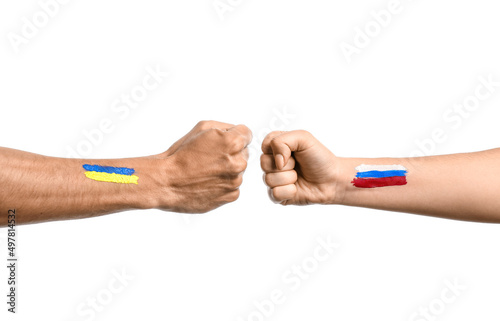 Clenched fists of male and female hands with painted flags of Ukraine and Russia on white background