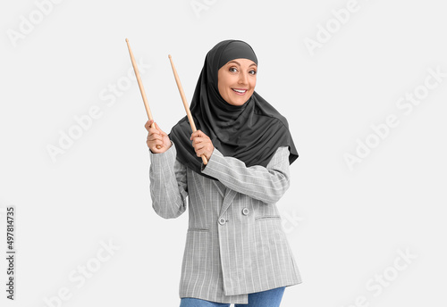 Muslim music teacher on light background