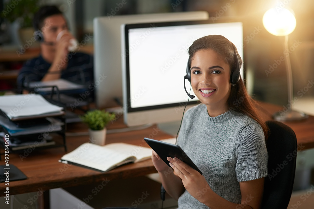 Looking up ways to help the customer even more. Shot of young agents working in a call center. Looking up ways to help the customer even more. Shot of young agents working in a call center.