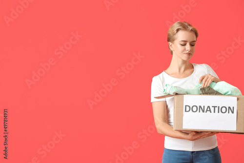 Young woman holding box wit...