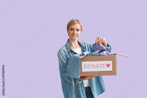 Young woman holding box wit...