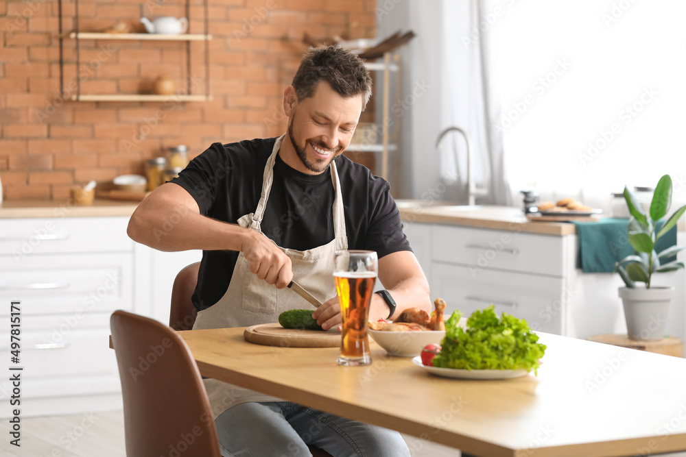 Handsome man preparing lunch in kitchen Handsome man preparing lunch in kitchen