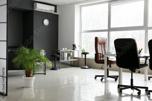 Interior of stylish office with modern furniture and big window