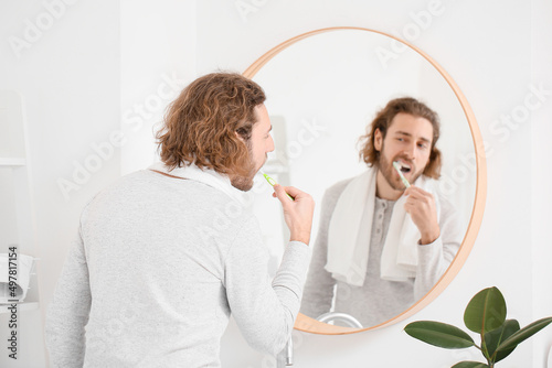 Handsome young man brushing...