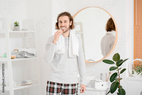 Handsome young man brushing...