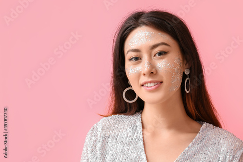 Young Asian woman with glit...
