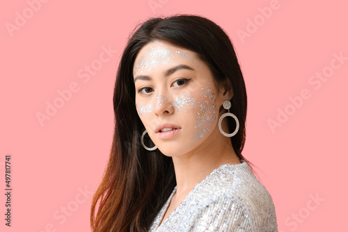 Young Asian woman with glit...