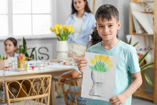 Cute boy with picture paint...