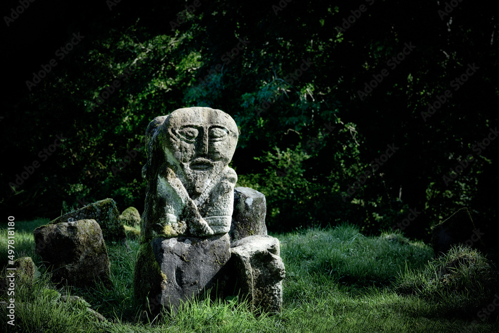 The Janus Figure in early Christian Caldragh graveyard, Boa Island, Fermanagh, N. Ireland. Double headed ancient stone carving. This is the west face