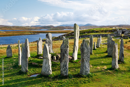 Tursachan prehistoric stones at Callanish, isle of Lewis, Scotland. aka Callanish I. Centre monolith, circle stones and chambered tomb looking S. East