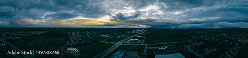 Aerial panorama of the district around Brannon crossing shopping district between cities of Lexington and Nicholasville, Kentucky during late evening dramatic cloudscape #497818769