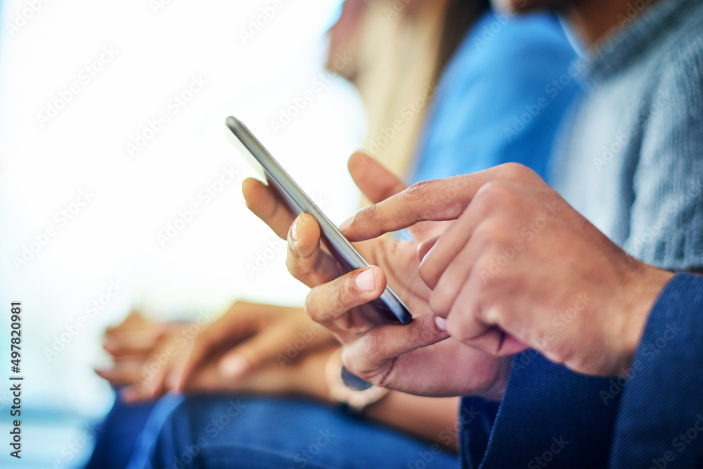 Modern technology is the new trend. Cropped shot of unrecognizable businessman using a smartphone during a conference in a modern office. Modern technology is the new trend. Cropped shot of unrecognizable businessman using a smartphone during a conference in a modern office.