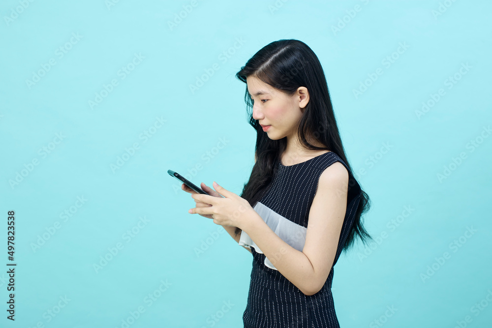 Surprised young Asia lady using mobile phone with positive expre