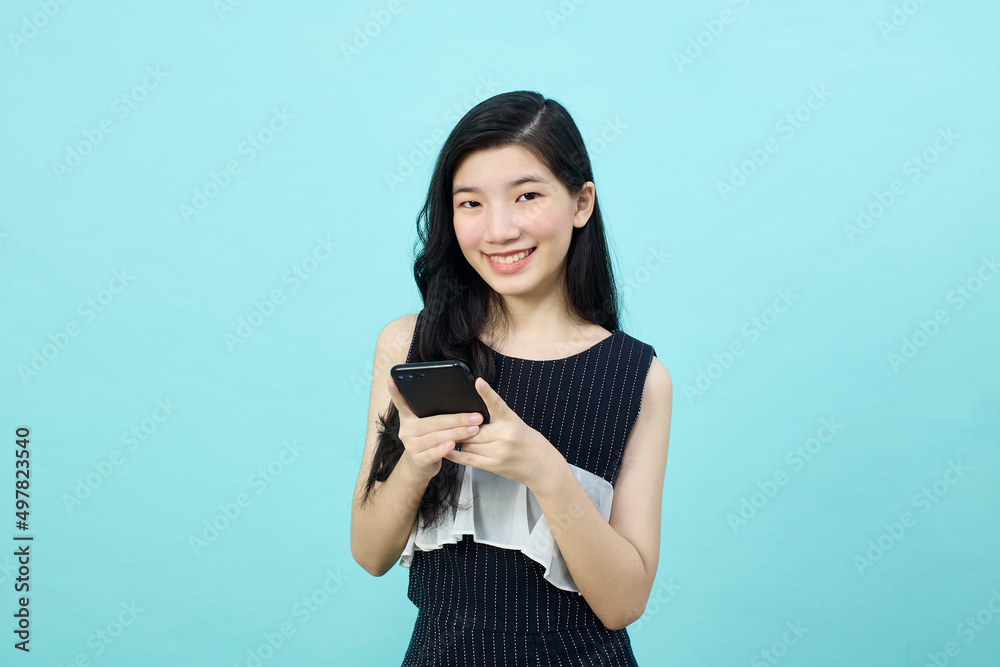 Surprised young Asia lady using mobile phone with positive expre Surprised young Asia lady using mobile phone with positive expre