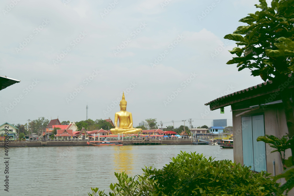 The attitude of meditation buddha near the river at Nonthaburi, Thailand.