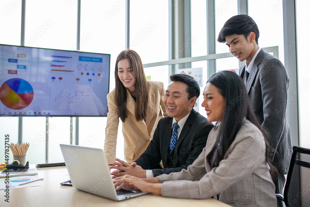 Asian business team male and female colleagues talking at work share ideas  with laptop, Happy colleagues work together on computer in office.