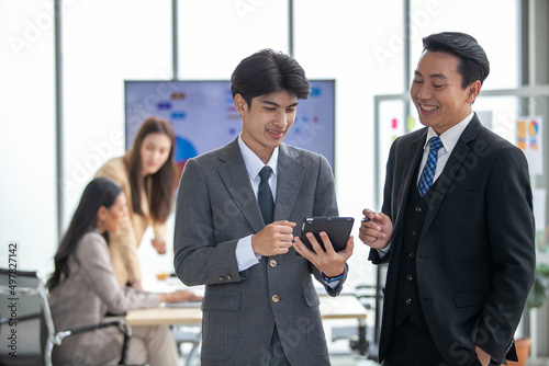 Business team colleagues talking at work share ideas with tablet, Happy colleagues work together in office.