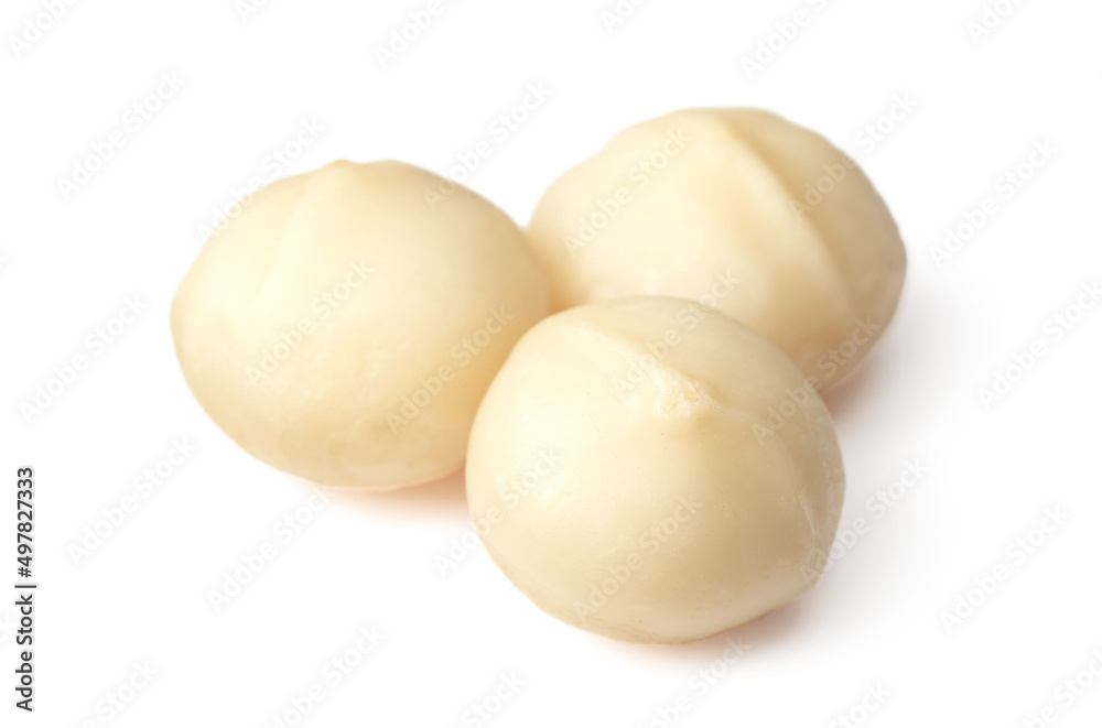 Unshelled macadamia nuts isolated on white background.