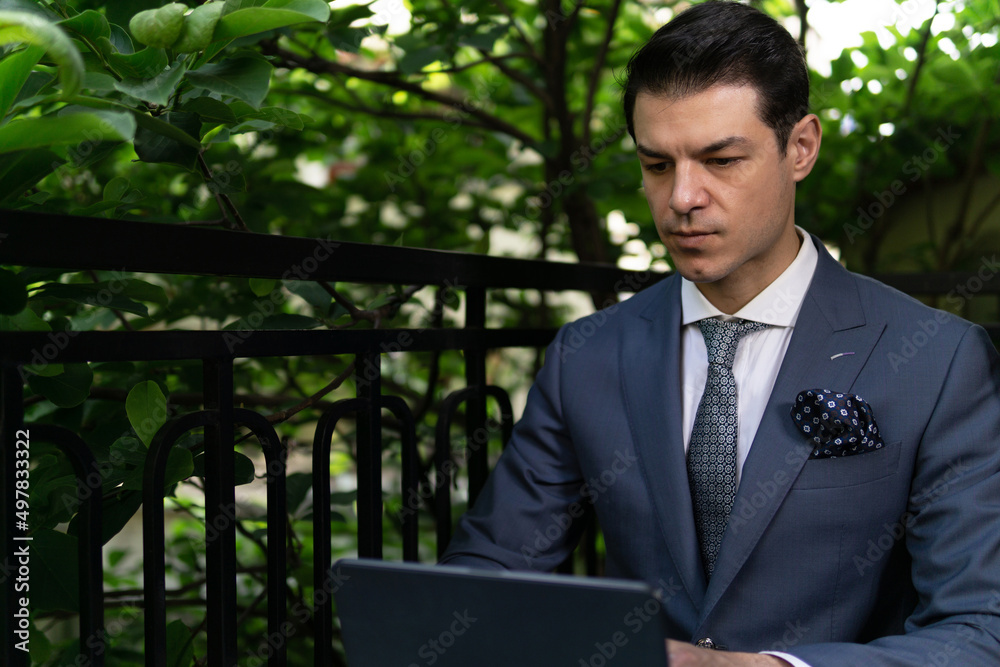 Portrait of handsome successful man working on digital tablet while sitting on beautiful terrace. Portrait of handsome successful man working on digital tablet while sitting on beautiful terrace.