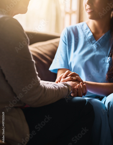 Ill be the support you need. Cropped shot of a nurse holding a senior womans hands in comfort.