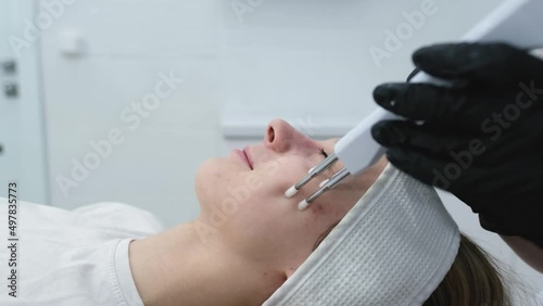 Cosmetic procedure to improve the condition of the skin of the face with microcurrents. Cosmetology and professional facial skin care.