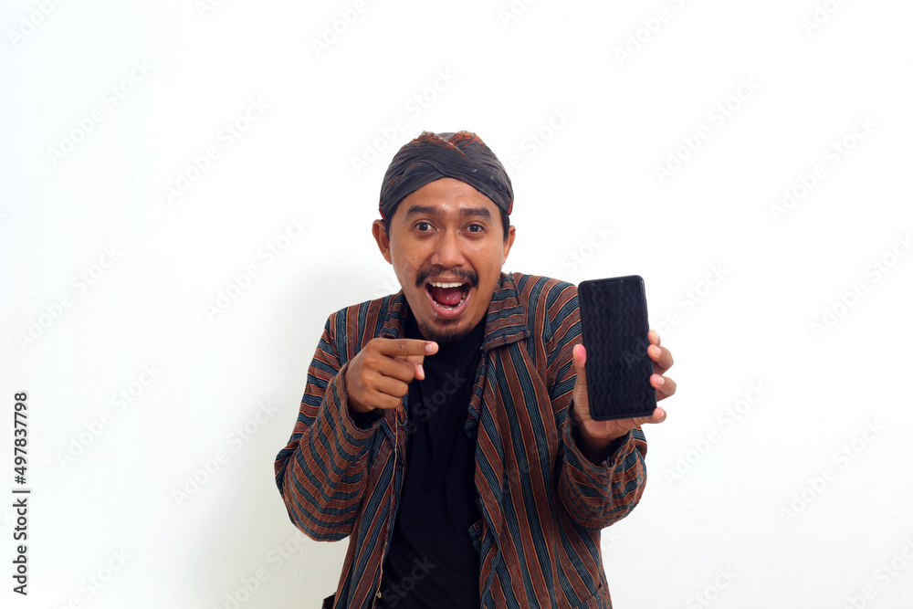 asian man standing in traditional costume.holding cellphone.over white.pointing to cell phone asian man standing in traditional costume.holding cellphone.over white.pointing to cell phone