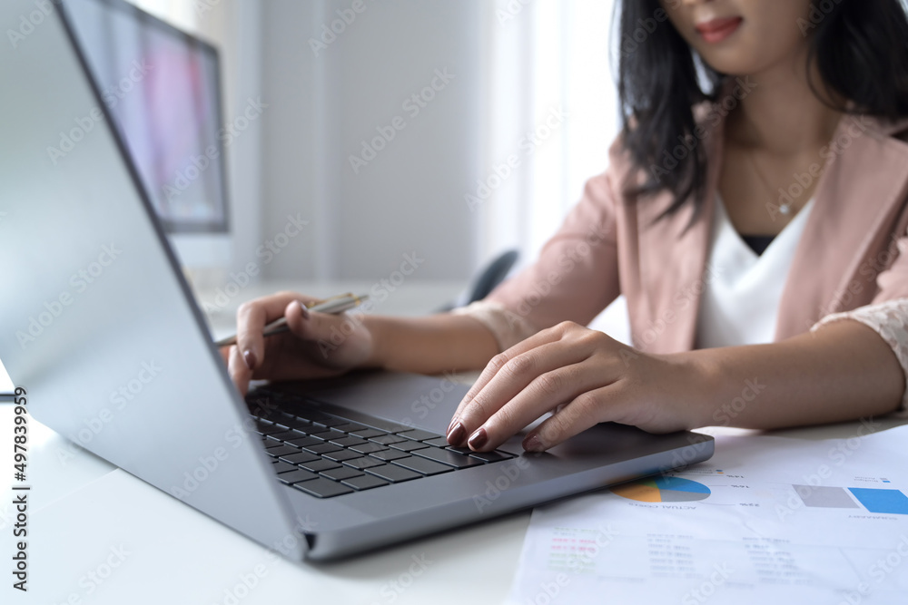 Young businesswoman hands typing on laptop computer while working at office desk. Young businesswoman hands typing on laptop computer while working at office desk.