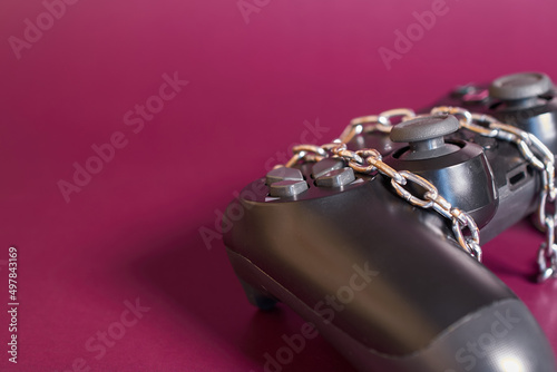 Gambling addiction. The remote from the game console is rewound by a chain