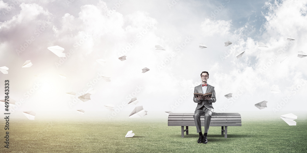 Young businessman or student studying the science and paper planes fly around Young businessman or student studying the science and paper planes fly around