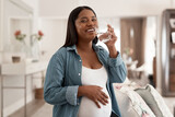 Got to stay hydrated for good health. Portrait of a pregnant woman drinking a glass of water at home.