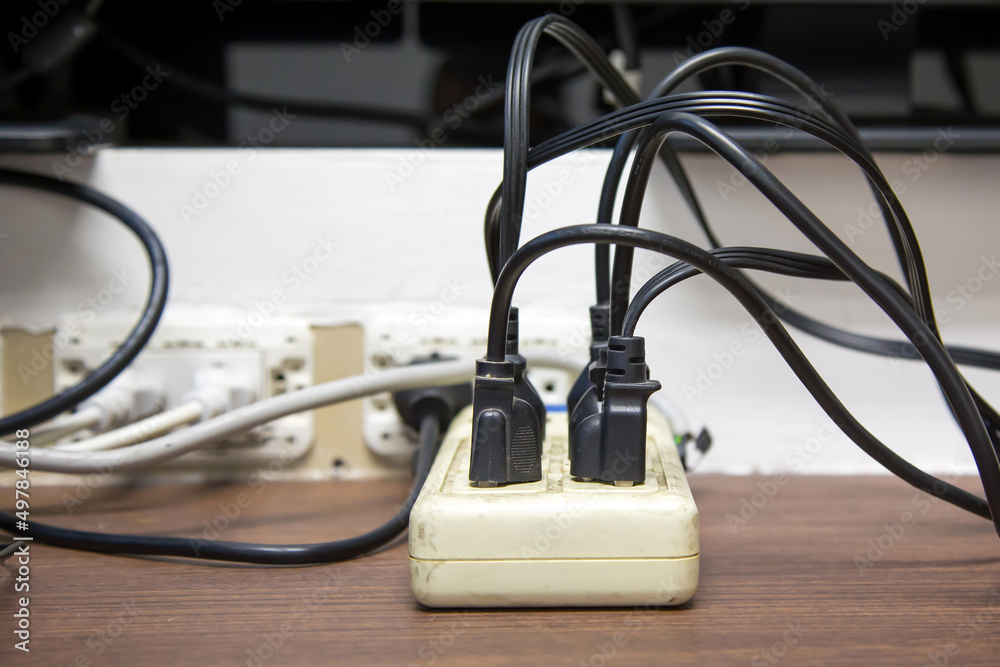 Old and damaged electric adapter power plug has many appliances are plugged outlet socket concept of risk danger overloaded current electrical. Old and damaged electric adapter power plug has many appliances are plugged outlet socket concept of risk danger overloaded current electrical.