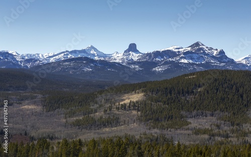 Alberta Foothills Landscape Panorama with Distant Canadian Rocky Mountain Front Range Peaks. Scenic Alberta Foothills Hiking on Sunny Early Springtime Day.