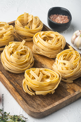 Pasta ingredients Tagliatelle with Italian food ingredients, on white stone  background