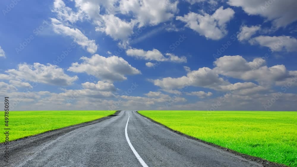 twisted asphaltic road among green fields under a dense clouds time lapse scene twisted asphaltic road among green fields under a dense clouds time lapse scene