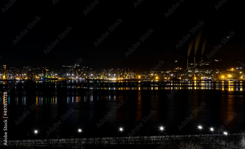 Night panoramic view of the port, cranes and other port infrastructure. Novorossiysk trading port on the Black Sea, Tsemesskaya bay