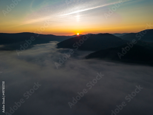 Sunrise over the fog in the Ukrainian Carpathians. Aerial drone view.